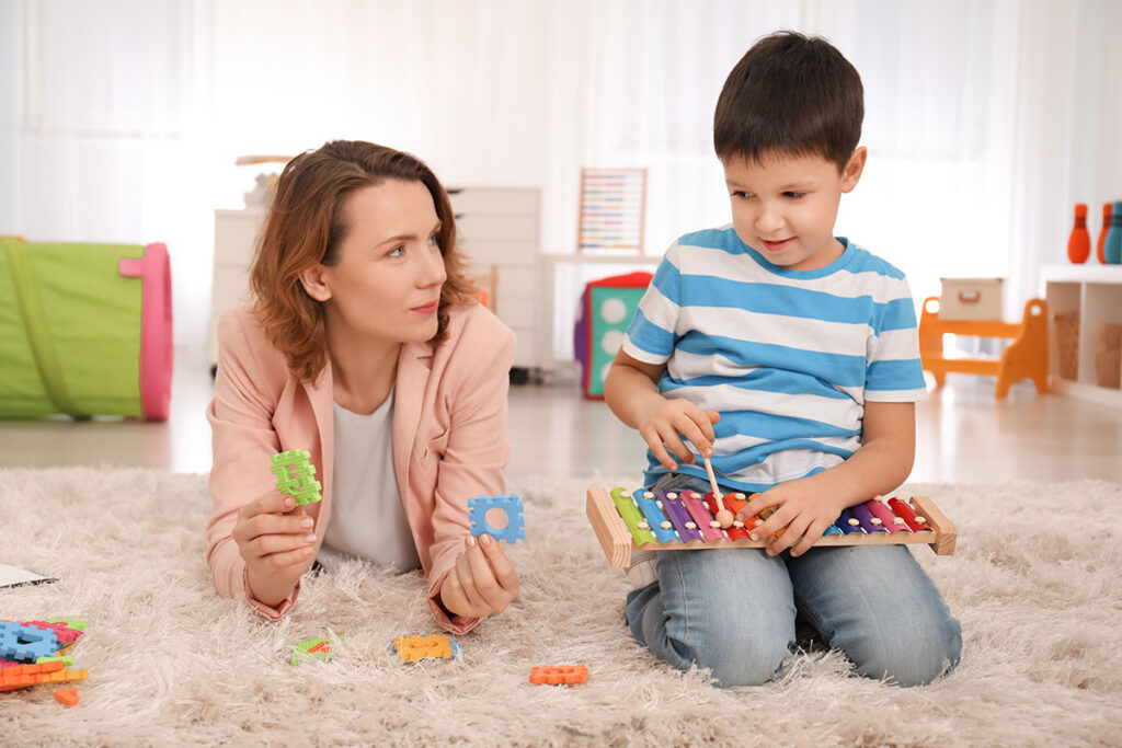mother playing with autistic child